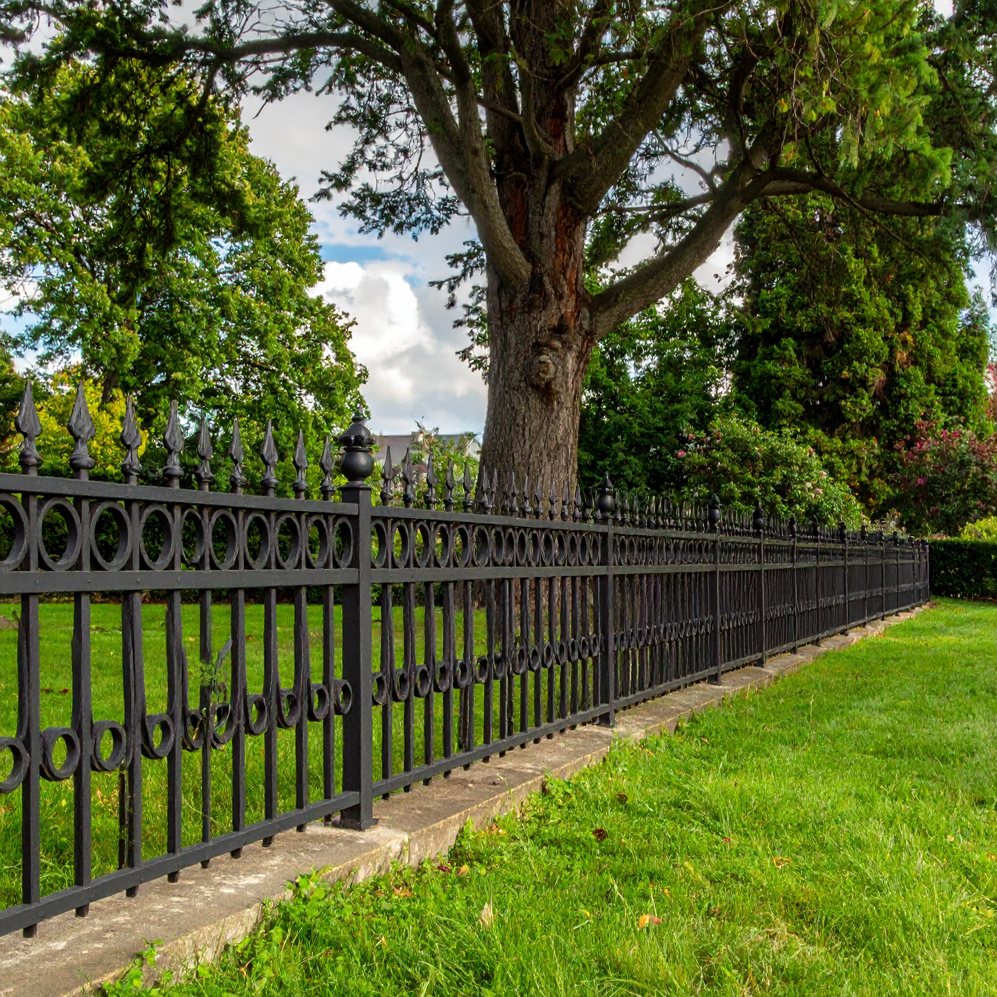 Black wrought iron fence, stone base.-deck builder-San Antonio, Texas