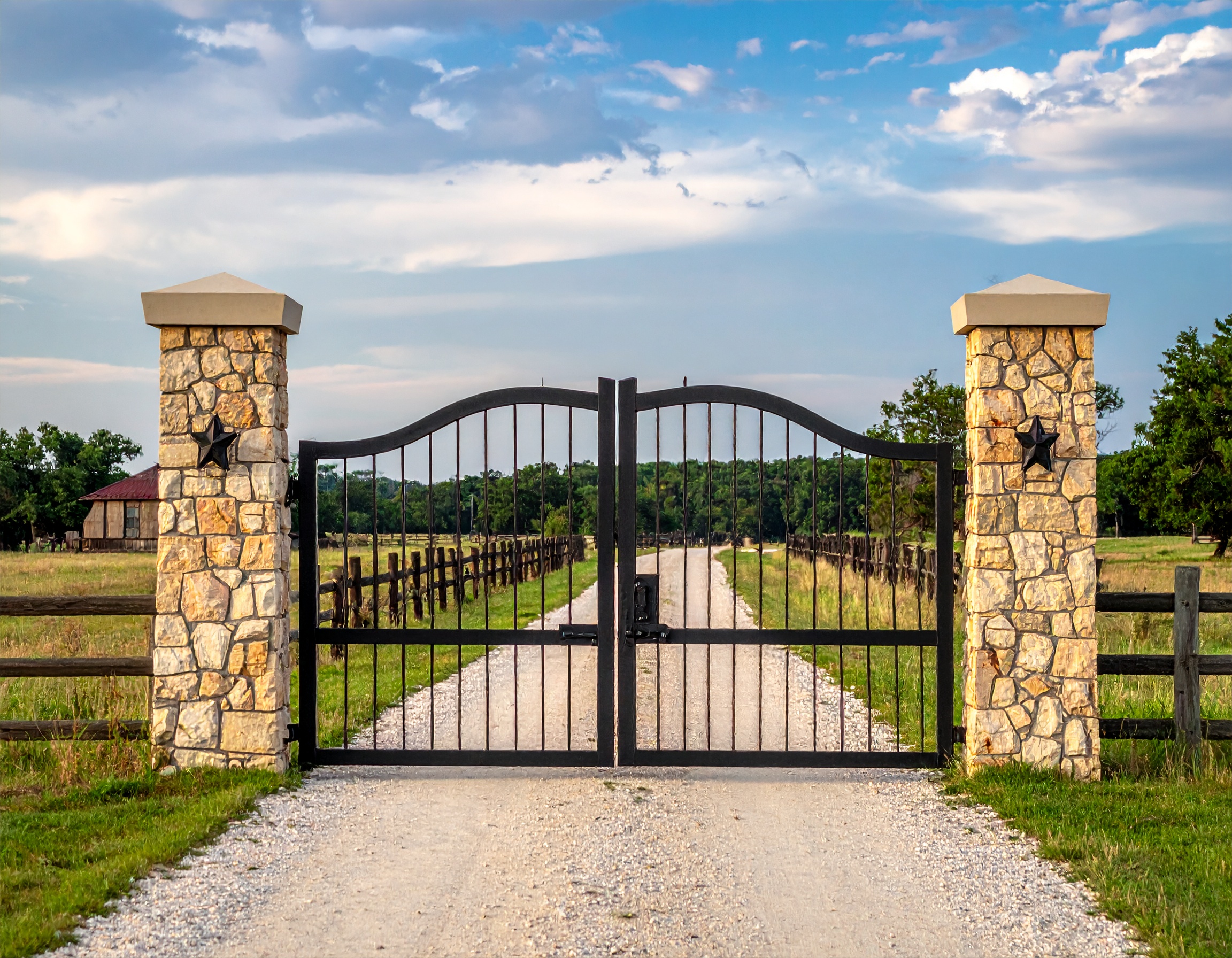 Black metal gate with stone pillars-deck builder-San Antonio, Texas