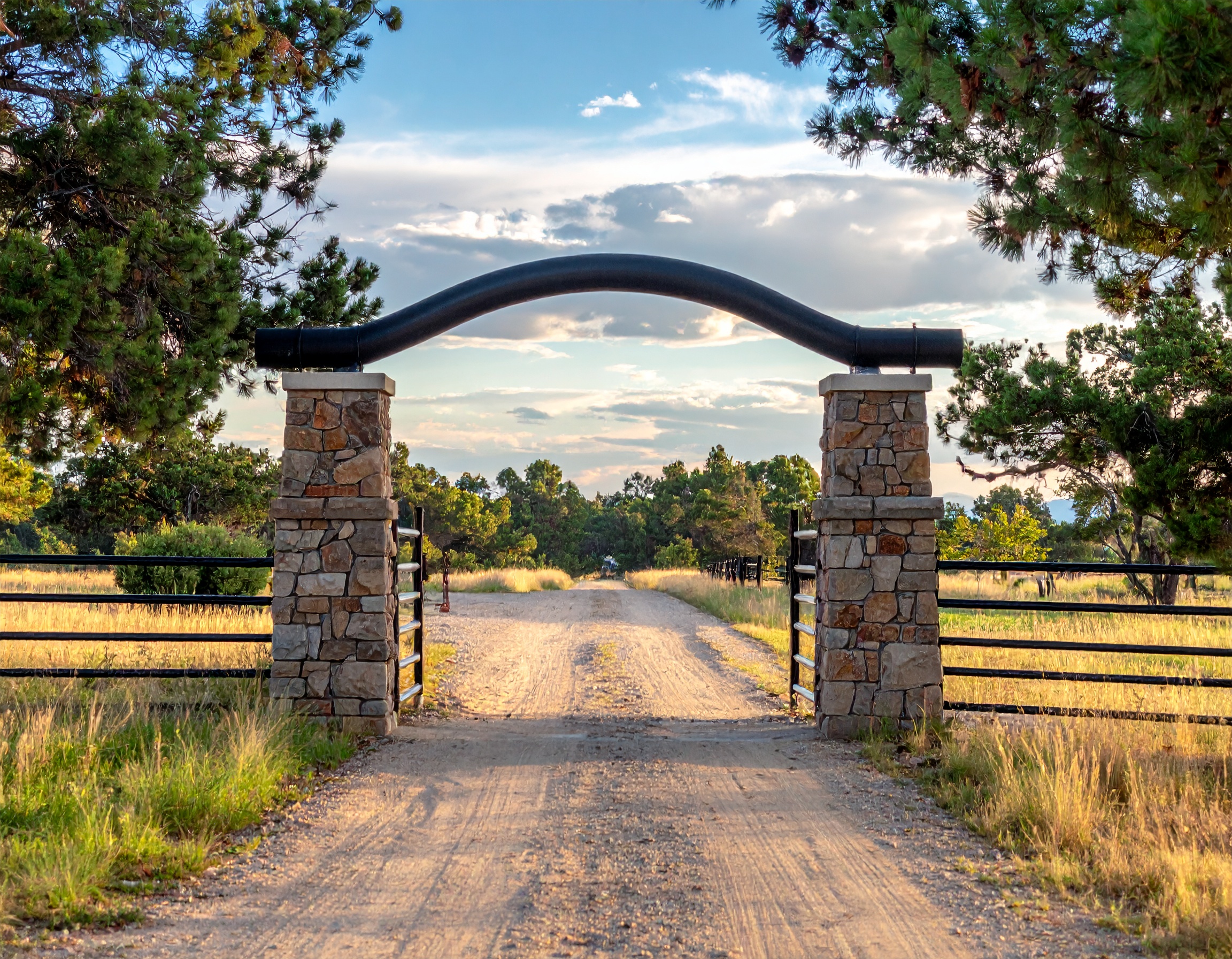 Stone pillars with black metal gate-deck builder-San Antonio, Texas