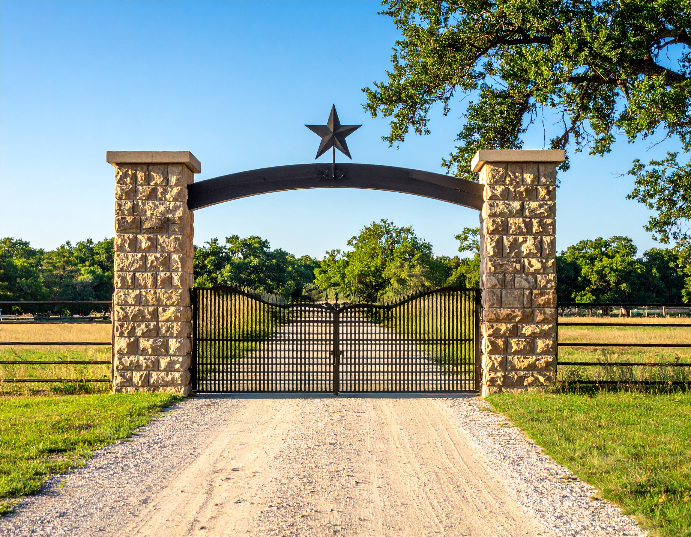 Stone pillars with metal star gate.-deck builder-San Antonio, Texas