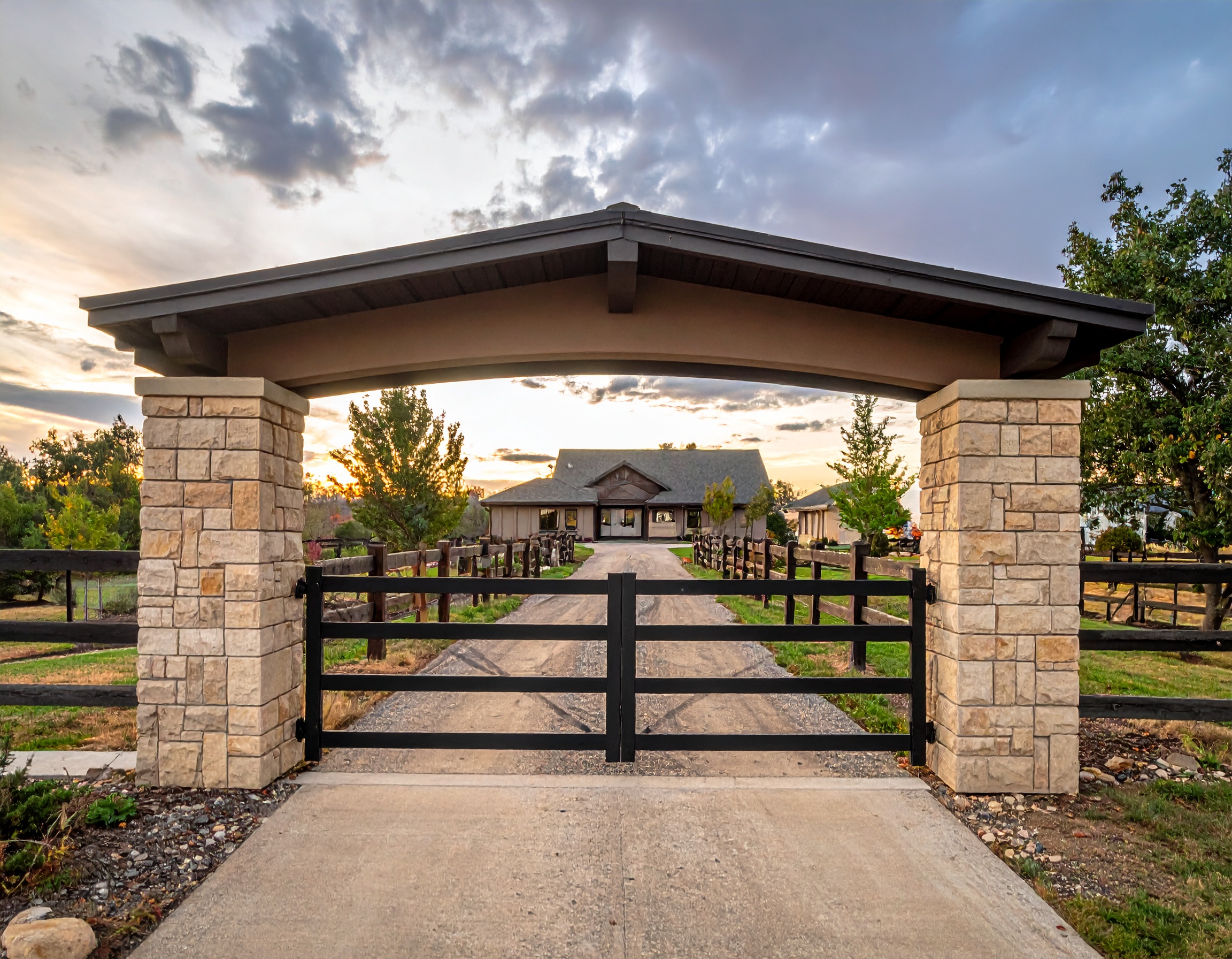 Stone pillars with black metal gate-deck builder-San Antonio, Texas