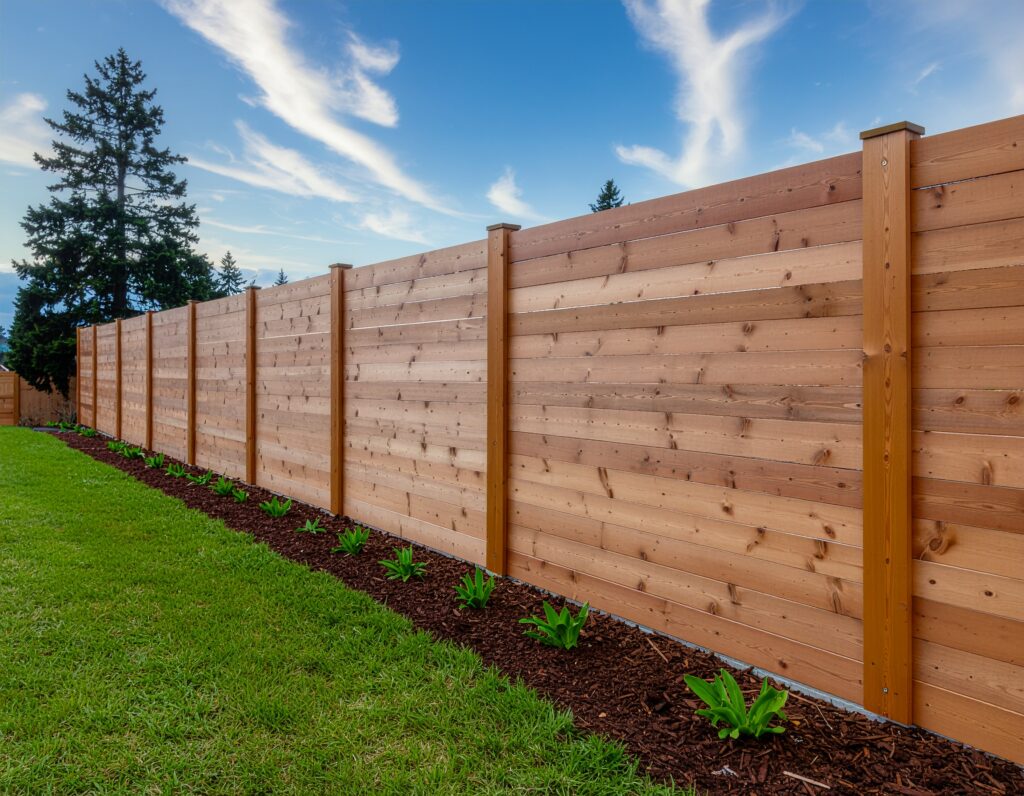 backyard bordered by a horizontal cedar privacy fence made of smooth wooden planks 333287 - San Antonio Deck and Fence Works